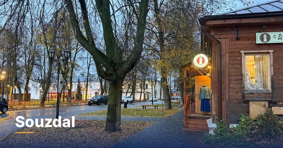 Une rue de Souzdal un matin d’automne, lampadaires allumés, pavés mouillés et une boutique en bois avec un costume traditionnel dans l’entrée